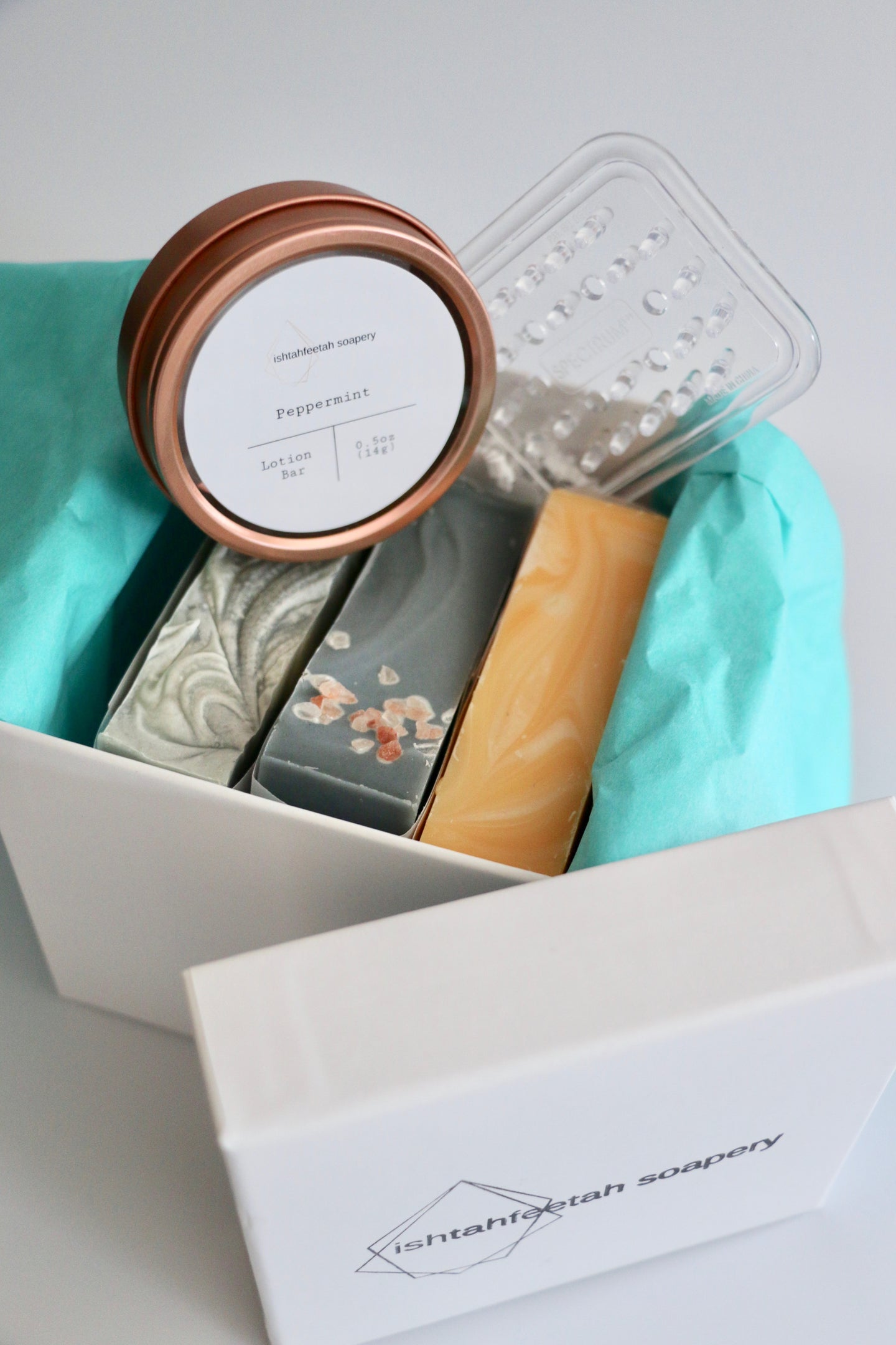 Gift box with three handcrafted soaps, a soap lift, and a mini lotion bar.
