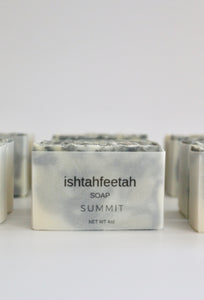 Vellum paper packaging.  Green, dark grey, and white swirled natural, handcrafted soap.